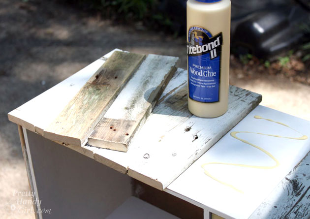 Tite Bond gluing picket pieces to cabinet