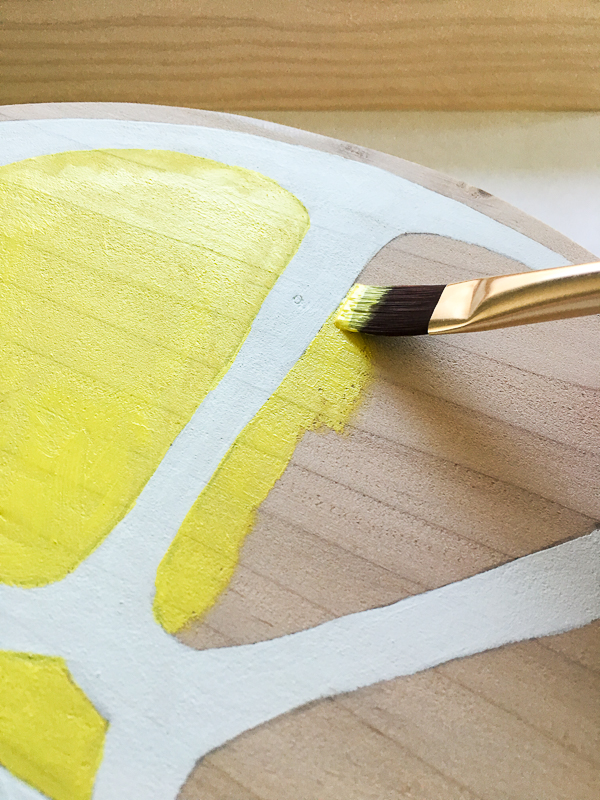 Paint the inside segments and outside edge of the lemon bright yellow.
