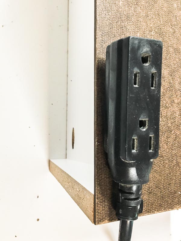 Attach an extension cord with extra outlets to the back of the cordless drill storage box for battery chargers.