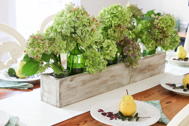 Green and purple hydrangeas in rustic wood trough. Build Your own Rustic Trough Centerpiece tutorial.