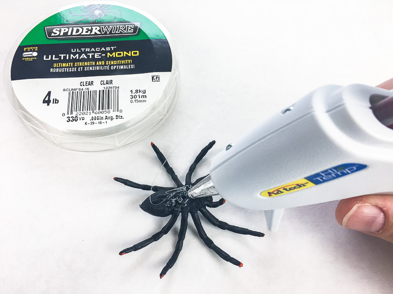 Add fishing line to the back of the spider to hang in the Halloween sign.