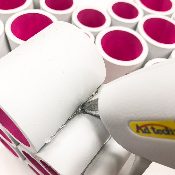 Apply a bead of hot glue to each side of the PVC pipe to form your heart decoration.