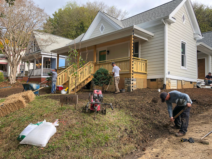 landscaper crew adding mulch and plantings