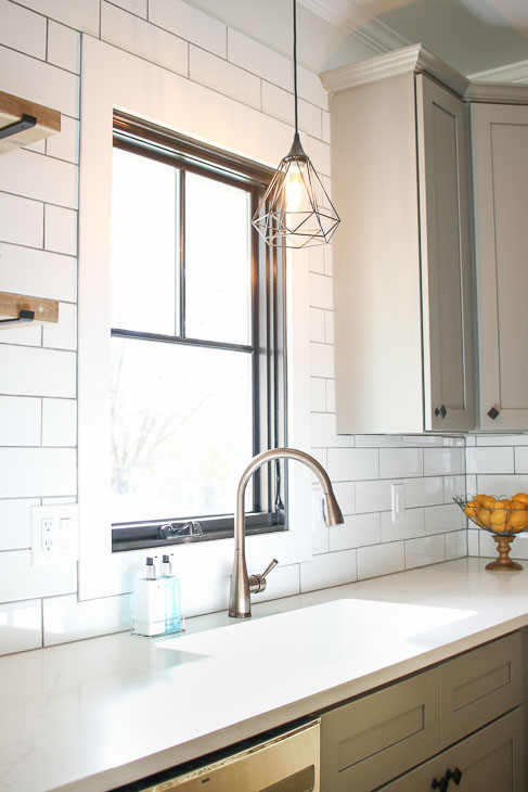 Plygem mira window with facet pendant light and subway tile