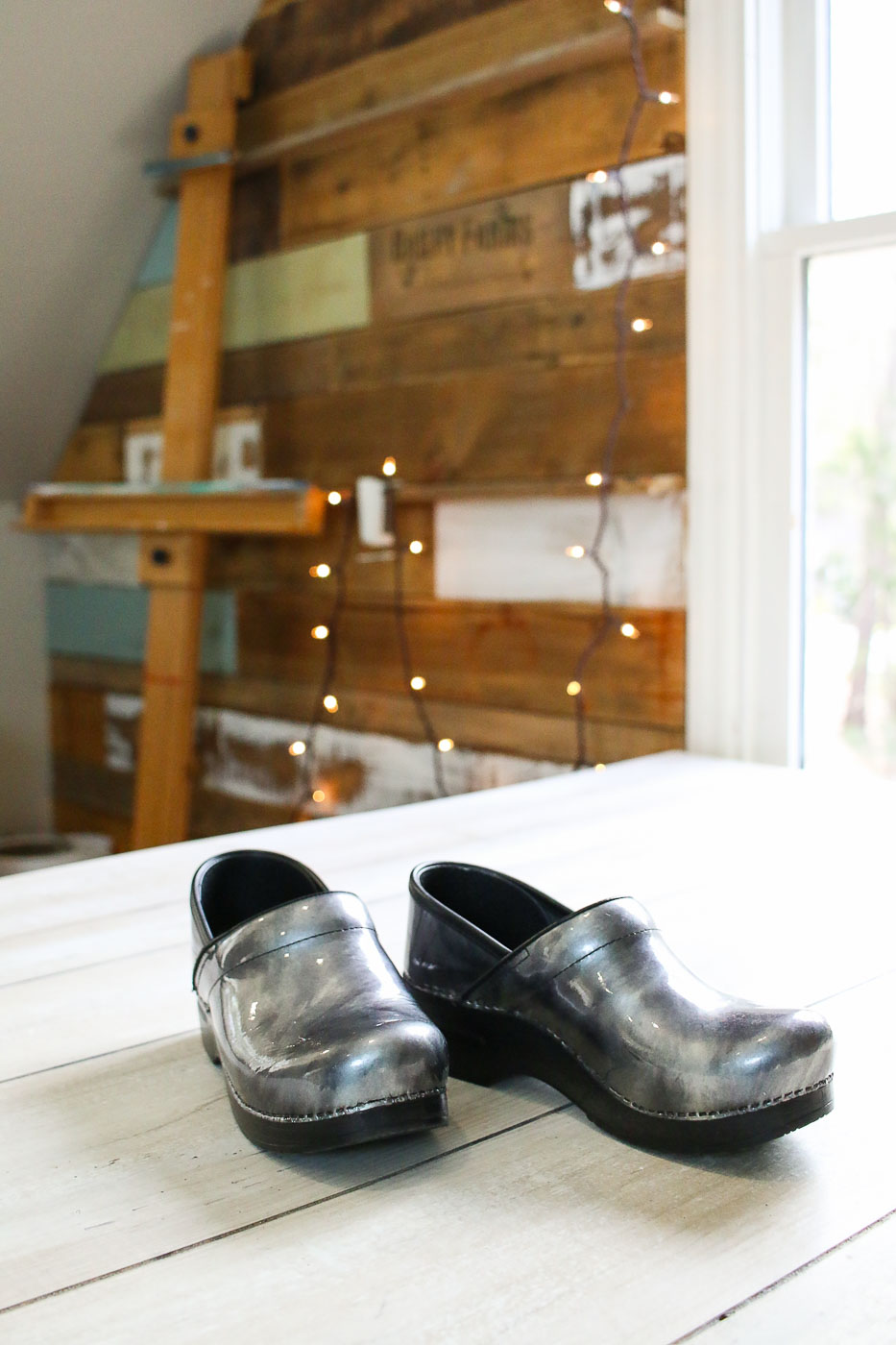 silver clogs on table