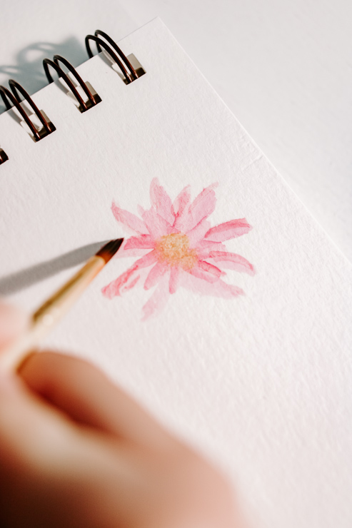 painting a watercolor petal on a daisy flower