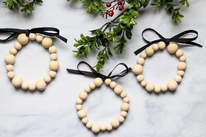 finished wooden bead ornaments on greenery